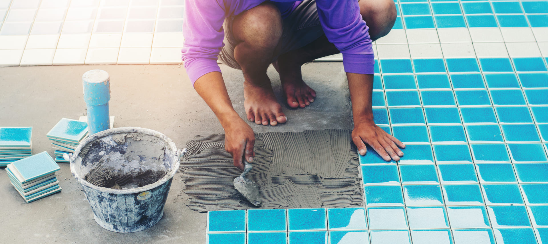 Professional poolside paver installation using high-quality, slip-resistant tiles for a safe and stylish pool deck.