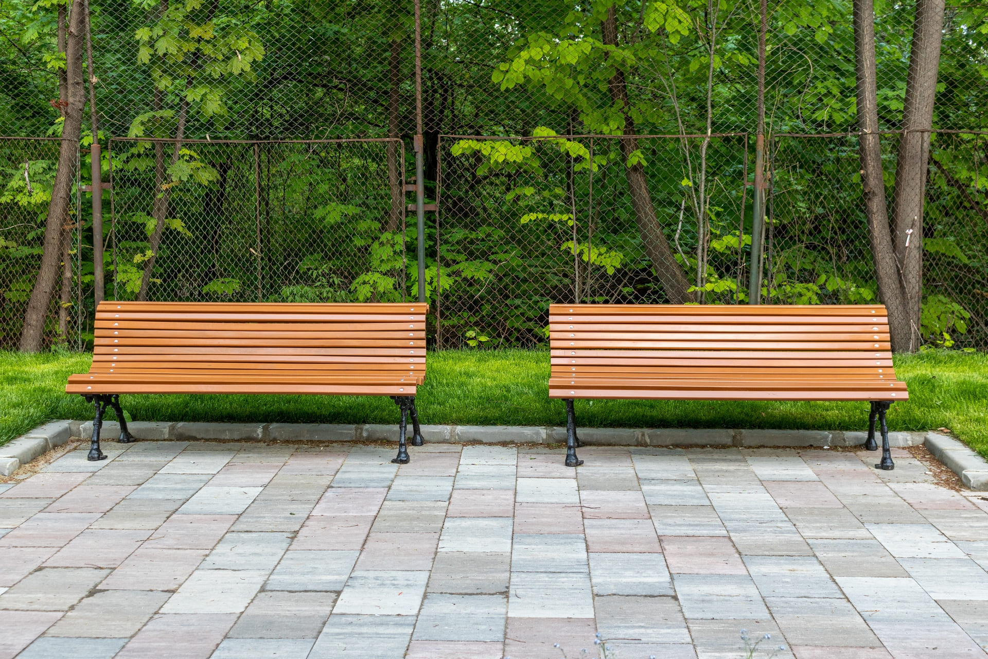 Stylish and durable patio pavers creating a welcoming outdoor seating area with wooden benches.