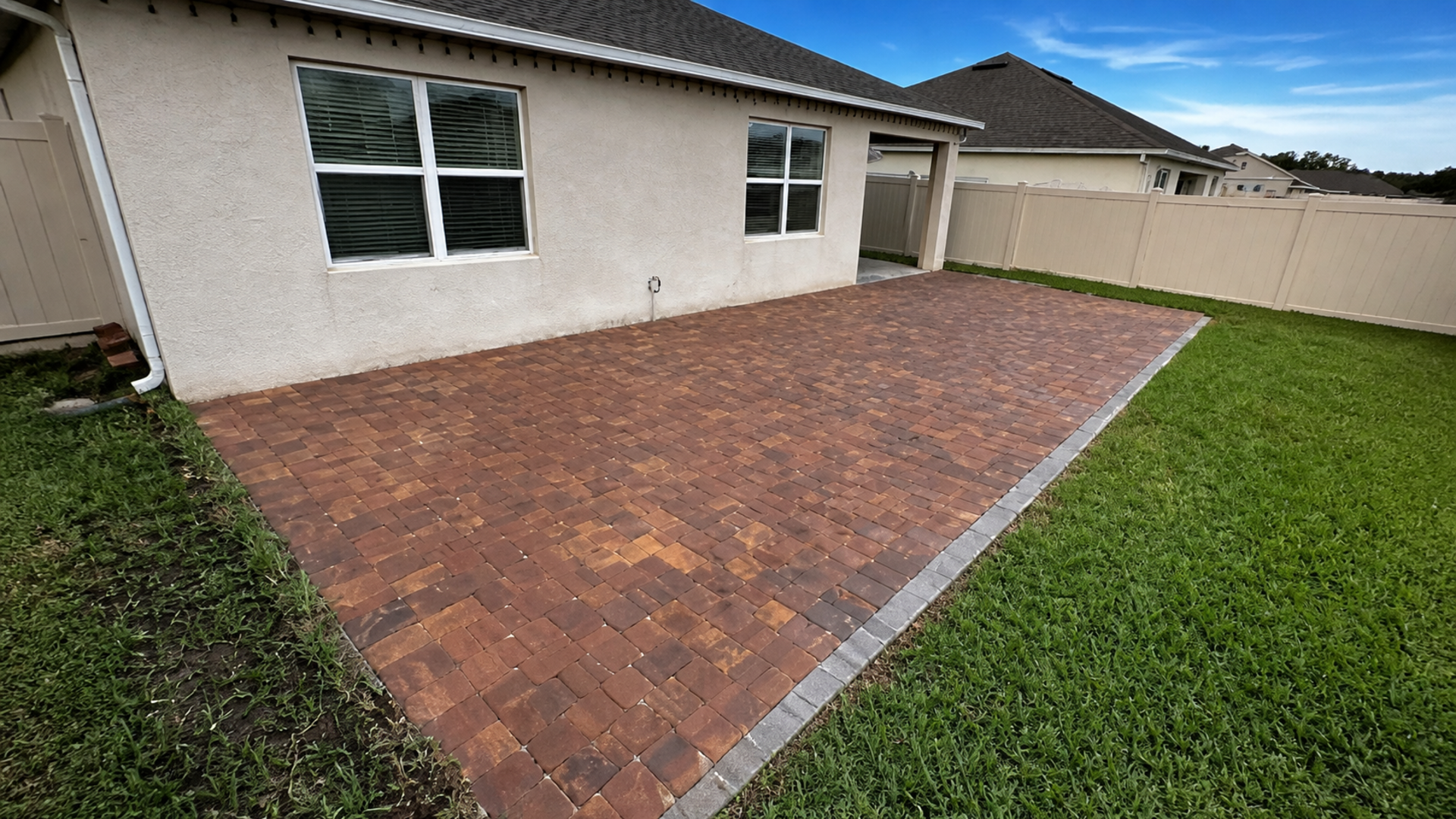 sloped backyard pavers on a completed JaxTeller Brick Pavers project